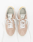 Pair of pink sneakers with white laces on a white background