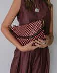 Petite Moyen Messenger Raisin/Petal Woven Checker held by model in pink set