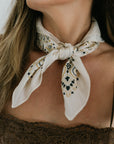 The Silk Bandana Cream close up tied around neck