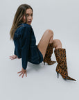 model wearing denim jacket, denim mini skirt and leopard boots