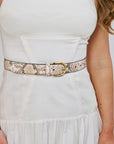 Person wearing a white dress with The Snake Print Juni Belt