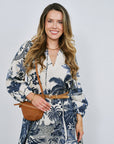Woman wearing a floral dress with a white background, close up