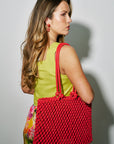 Woman with Sandy Bag on shoulder