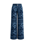 A pair of wide-leg pants in a dark indigo blue fabric featuring a lighter blue floral and geometric pattern, shown against a plain white background.