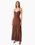 model wearing a brown dress on a white background