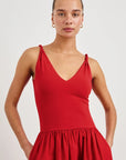 Woman wearing a red dress against a white background front view