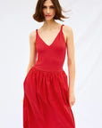 Woman wearing a red dress on a white background front view