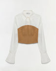 White blouse with a brown leather patch on a white background