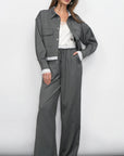 Woman wearing a gray outfit with a white background