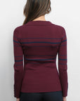 Maroon sweater with blue stripes worn by a person on a white background, back