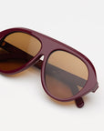 garnet oversized sunglasses with amber lenses on a white background