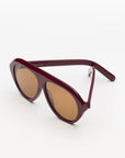 garnet oversized sunglasses with amber lenses on a white background