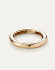 Gold ring with 'Jenny Bird' engraving on a light gray background
