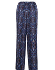 A pair of wide-leg trousers featuring an intricate geometric and floral pattern in navy blue, burgundy, and light blue, displayed against a solid white background.