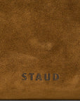 Close-up of Cy Convertible Bag Cigar with STAUD embossed in dark lettering near the bottom.