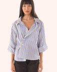 Woman wearing a blue and white striped shirt on a white background front view