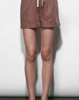 Brown shorts worn by a person against a white background