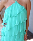 Mint green ruffled dress with a neutral background