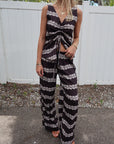 Woman wearing a black and white striped set standing outdoors.