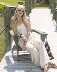 Woman in Ramsey Linen Wide Leg Pant sitting on a wooden bench outdoors