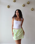 The Boxer Mini Skirt in Dayglow front view on model