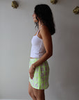 The Boxer Mini Skirt in Dayglow side view on model