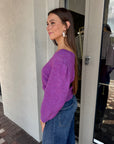 Pollen Reversible Sweater side view, buttons in front