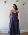 Bardot Dress in Navy front view on model with hands in pockets