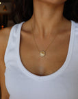 Mandala Medallion Necklace showing gold side on model's neck