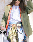 Model wearing The Quilted Liner Parka opened with a stripe button down and print skirt