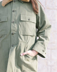 The Quilted Liner Parka close up with model's hand in pocket