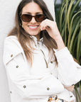 The Embroidered Crop Pullover Daisies close up with Tommie Havana Polarized Sunglasses