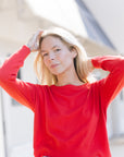 Polly Sweater Red front, model's arms up