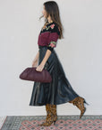model wearing burgundy clutch