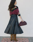 model wearing burgundy clutch