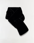 A black fuzzy knit scarf, possibly faux fur or velour, styled in a loose knot on a plain white background.
