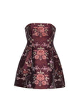A strapless mini dress featuring a structured, fitted bodice and a flared skirt, decorated with a luxurious floral brocade pattern in burgundy, pink, and green on a white background.