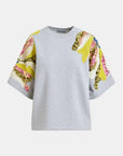Gray sweater with colorful floral sleeves on a white background