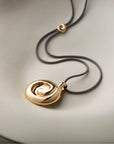 nico mirror pendant necklace flat on a cream background