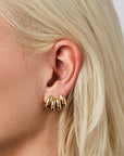 Two Mini Florence Earrings in Gold next to each other on model's ear