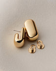 gold earrings on a white background