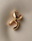 chunky gold hoops on a white background