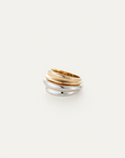 Three gold and silver rings stacked on a white background