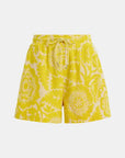 Yellow floral-patterned shorts on a white background