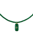 Green beaded necklace with a pendant on a white background