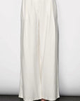 White wide-leg pants worn by a person on a plain background