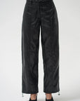 Black wide-leg pants with a glossy, slightly wrinkled texture, featuring a drawstring waist and drawstring hems, shown on a model against a light gray background.