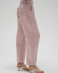 Person wearing pink pants and a matching top on a white background