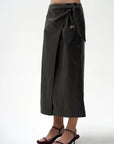 model wearing a brown wrap skirt on a white background