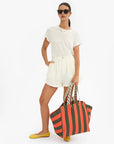 La Cote Beach Tote front view worn by model carrying strap with hand